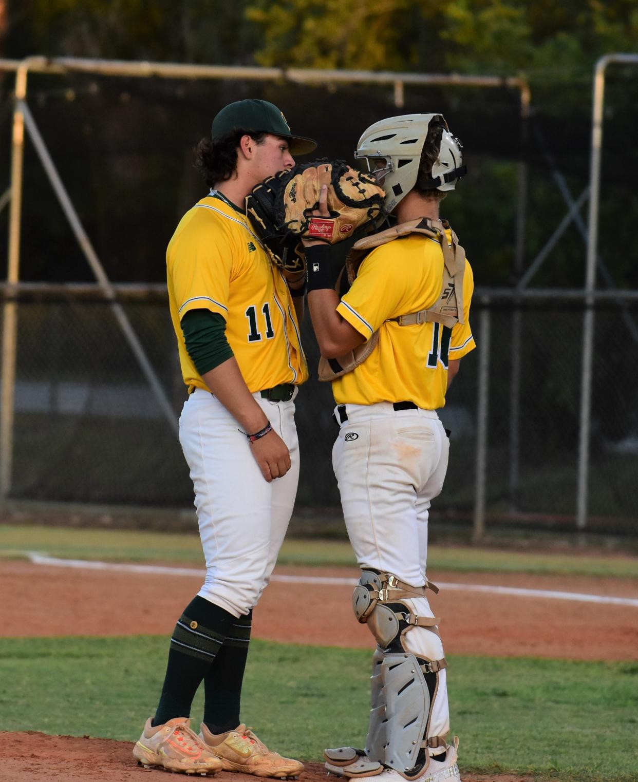 Suncoast's Brady Benevides and Brady King discuss strategy during an at-bat in a regular season game against Boca Raton on April 23, 2024.