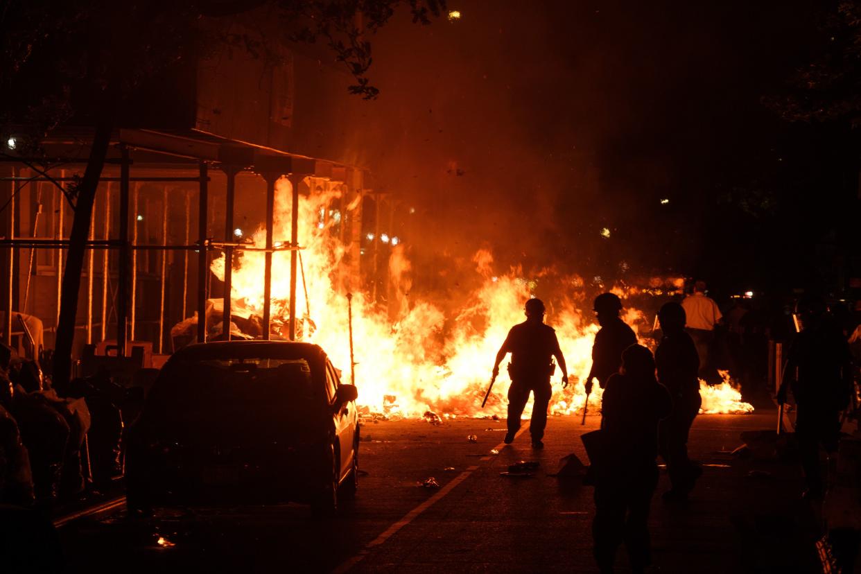 Police and firefighters respond after protesters set a large fire on E. 12th St. and Broadway in Manhattan on May 31, 2020. 