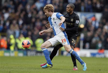 Manchester City's Fernandinho (R) challenges Blackburn Rovers' Chris Taylor during their FA Cup third round soccer match at Ewood Park in Blackburn, northwest England January 4, 2014. REUTERS/Phil Noble