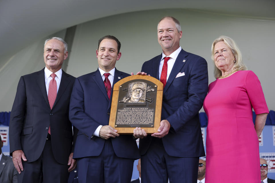 Commissioner of Major League Baseball Rob Manfred, left; Josh Rawitch, center left, president of the National Baseball Hall of Fame and Museum; Hall of Fame inductee Scott Rolen, center right; and Jane Forbes Clark, right, chair of the Board of Directors of The National Baseball Hall of Fame and Museum, pose for a photo during a National Baseball Hall of Fame induction ceremony Sunday, July 23, 2023, at the Clark Sports Center in Cooperstown, N.Y. (AP Photo/Bryan Bennett)