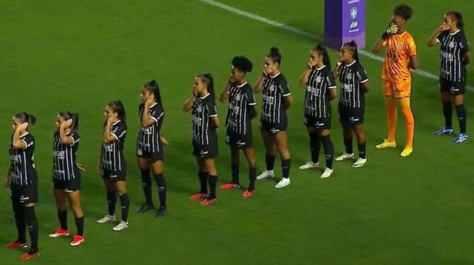 <span>Corinthians’ players cover their ears and mouths in protest before playing Santos.</span><span>Photograph: SporTV</span>