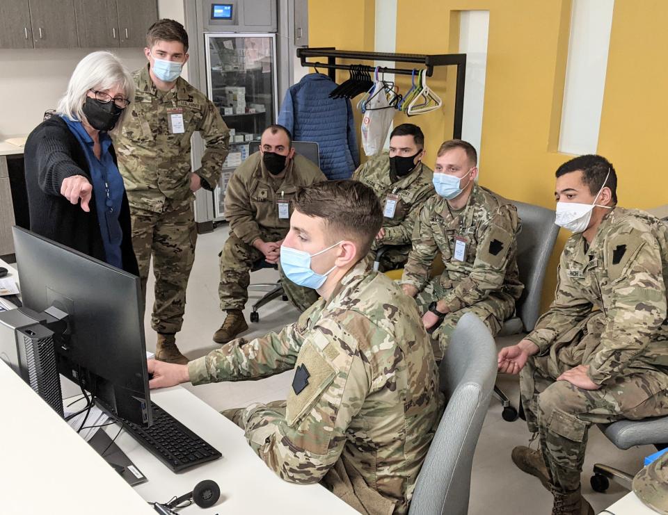 Brenda Myers of Meritus Health teaches members of the Maryland National Guard about the Meritus COVID-19 testing process Wednesday morning, Jan. 12, 2022. Standing with Myers is Daniel Marsh, a guard member who lives in Hagerstown.