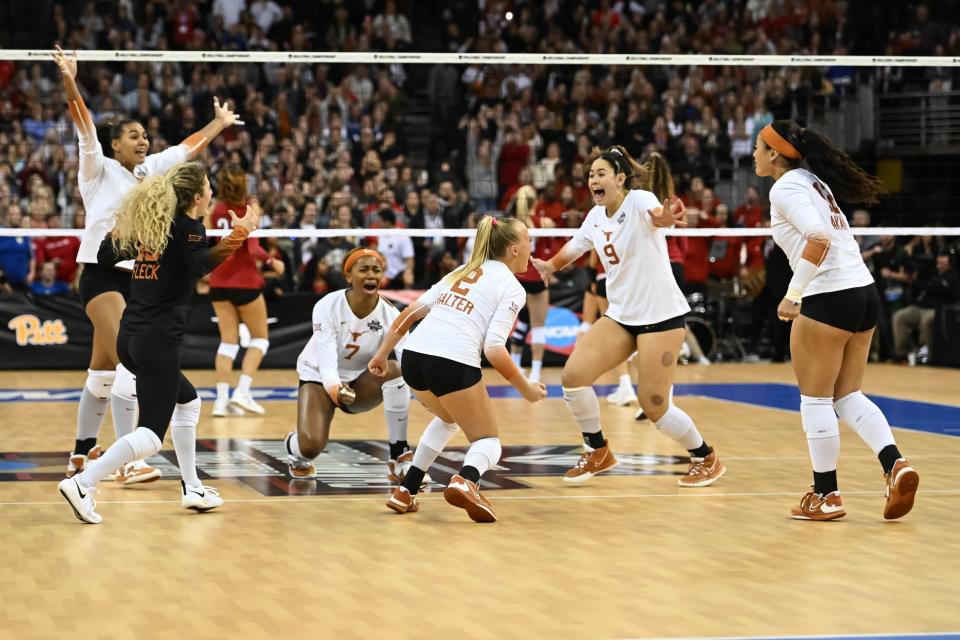 The Texas Longhorns celebrate match point against Louisville.