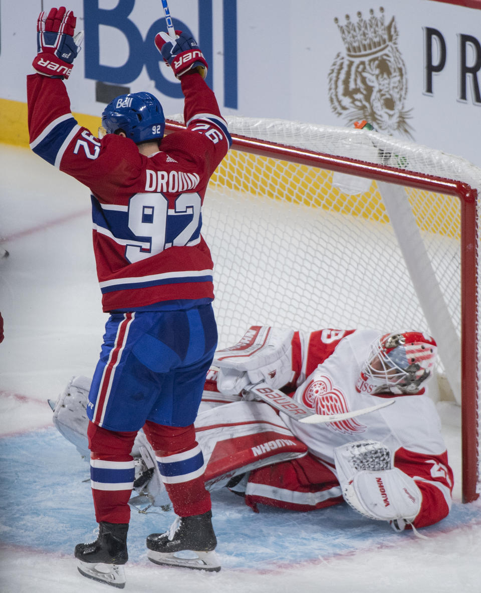 Montreal Canadiens' Jonathan Drouin reacts to a goal by teammate Christian Dvorak against Detroit Red Wings goaltender Thomas Greiss during the second period of an NHL hockey game Saturday, Oct. 23, 2021, in Montreal. (Graham Hughes/The Canadian Press via AP)