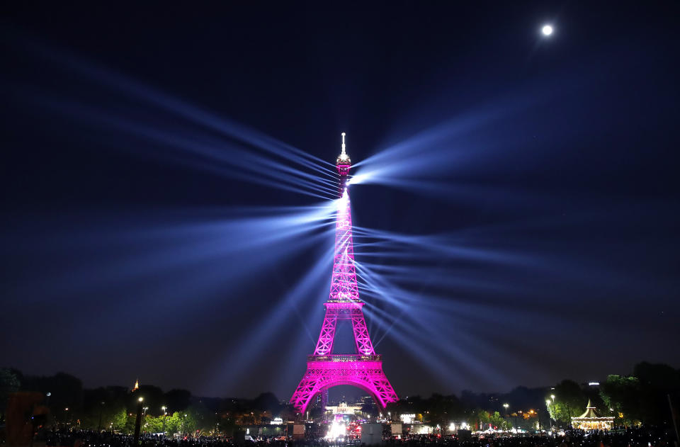 A light show illuminates the Eiffel Tower for its 130 year anniversary, in Paris, Wednesday, May 15, 2019. Paris is wishing the Eiffel Tower a happy birthday with an elaborate laser show retracing the monument's 130-year history. (AP Photo/Christophe Ena)