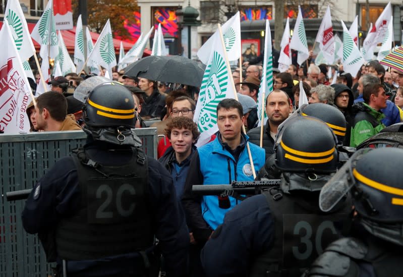 French farmers block the Champs Elysees avenue during a day of protest in Paris