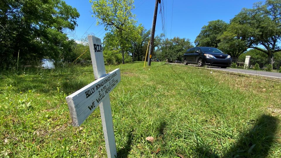A cross remembering Donnie Cayer stands at the site where he died on Horseshoe Drive in Alexandria. The cross was put there by a friend of Cayer's, who replaces it each time it's removed. Days after this photo was taken, the cross was gone.