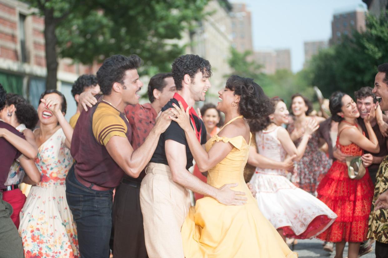 Extras surround David Alvarez and Ariana Dubose as they film the “America” scene from next year’s “West Side Story” movie musical.