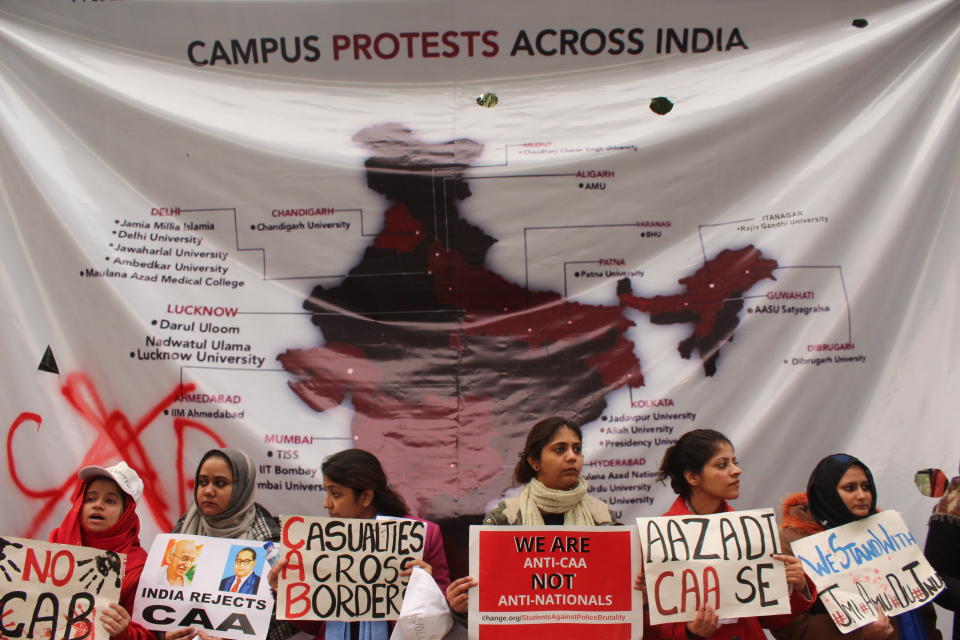 Students and local residents hold placards and raise slogans as they take part in a protest against the Citizenship Amandment Act (CAA) and National Register of Citizens (NRC), at Jamia Millia Islamia University, on December 19, 2019 in New Delhi, India. (Photo by Mayank Makhija/NurPhoto via Getty Images)