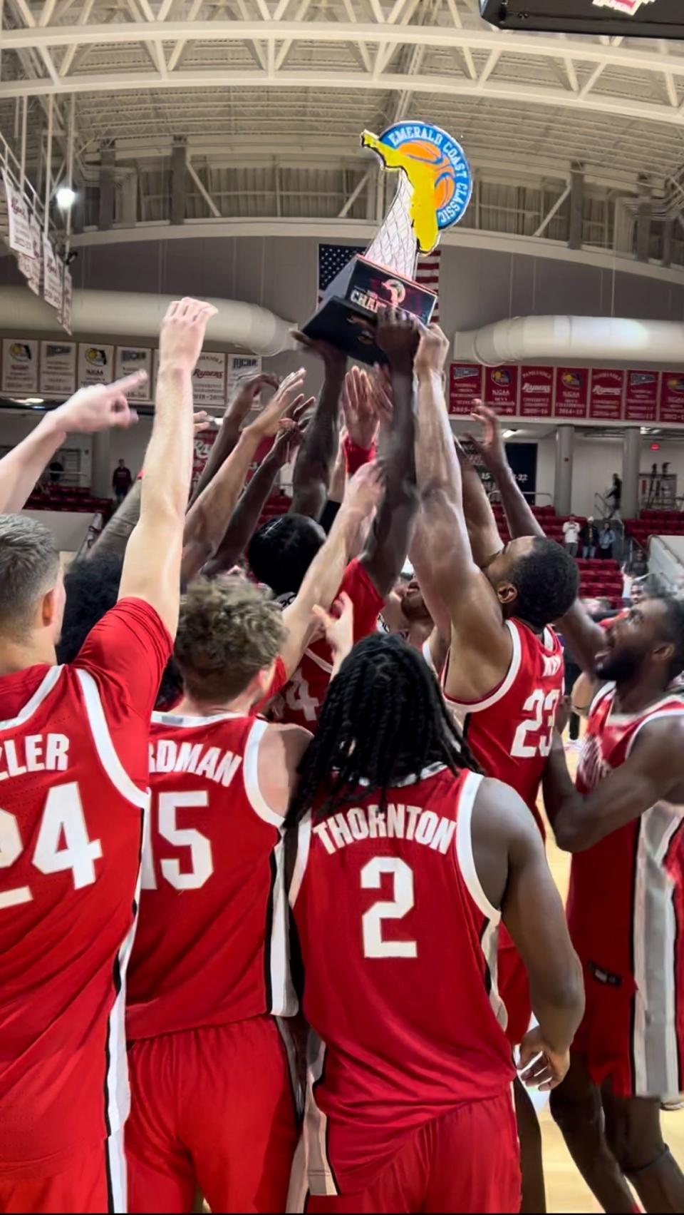 Ohio State's players hoist the Emerald Coast Classic championship trophy after beating Santa Clara inside Raider Arena at Northwest Florida State College on Nov. 25, 2023.