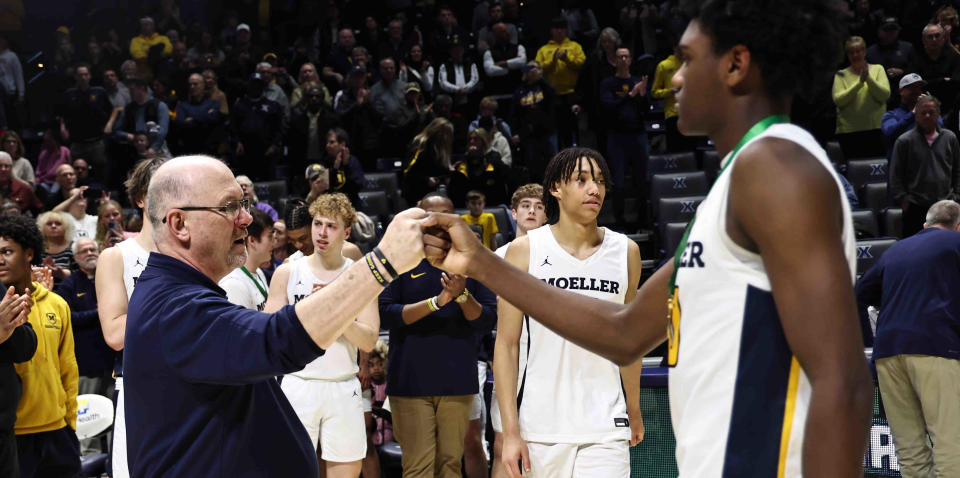 Moeller head coach Carl Kremer congratulates senior Eric Mahaffey after their district final win Sunday, March 10, 2024.