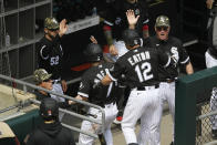 Chicago White Sox's Adam Eaton (12) and Tim Anderson (7) celebrate at the dugout with manager Tony LaRussa left, after Eaton hit a two-run home run during the fifth inning of a baseball game against the Kansas City Royals, Sunday, May 16, 2021, in Chicago. (AP Photo/Paul Beaty)