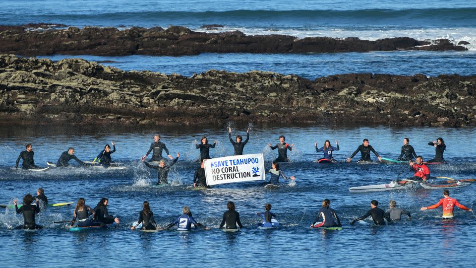 Surfers gather in in Guethary, southwestern France, during a demonstration  to protest against the development of the Olympic surfing venue in Polynesia and to preserve the Teahupoo site, on December 17, 2023. - Gaizka Iroz/AFP/Getty Images
