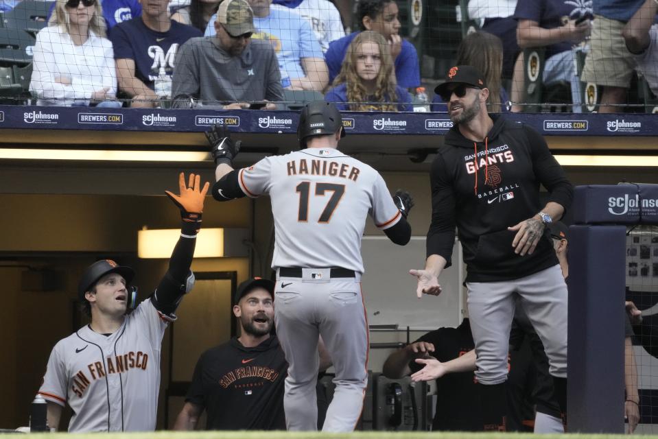 San Francisco Giants' Mitch Haniger is congratulated after hitting a two-run home run during the eighth inning of a baseball game against the Milwaukee Brewers Saturday, May 27, 2023, in Milwaukee. (AP Photo/Morry Gash)