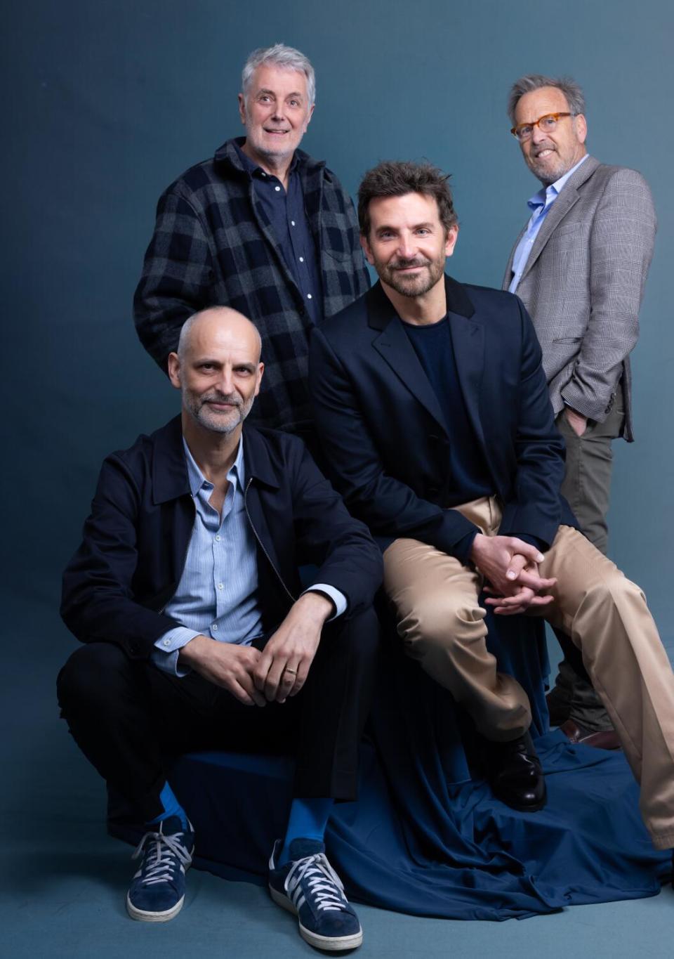 A group of film producers pose for a photograph.