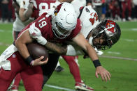 Arizona Cardinals quarterback Trace McSorley (19) is tackled by Tampa Bay Buccaneers cornerback Carlton Davis III (24) during the first half of an NFL football game, Sunday, Dec. 25, 2022, in Glendale, Ariz. (AP Photo/Rick Scuteri)