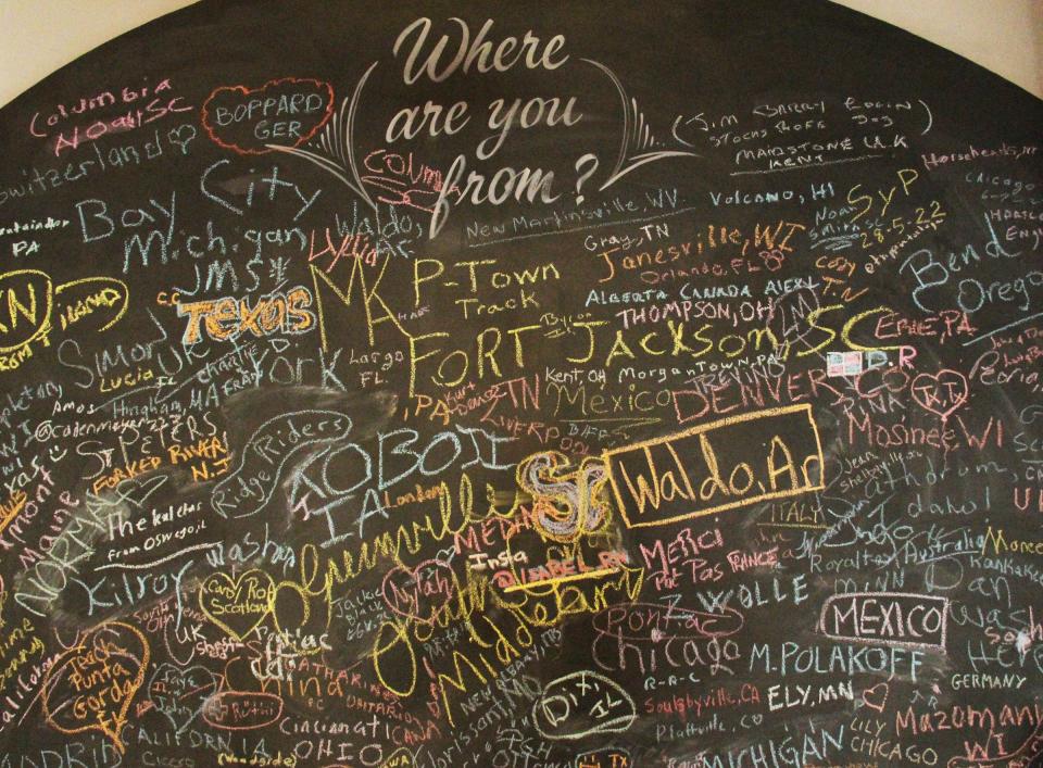 The Chalk Wall, which is located in the old City Hall building, allows visitors to write down where they are from.