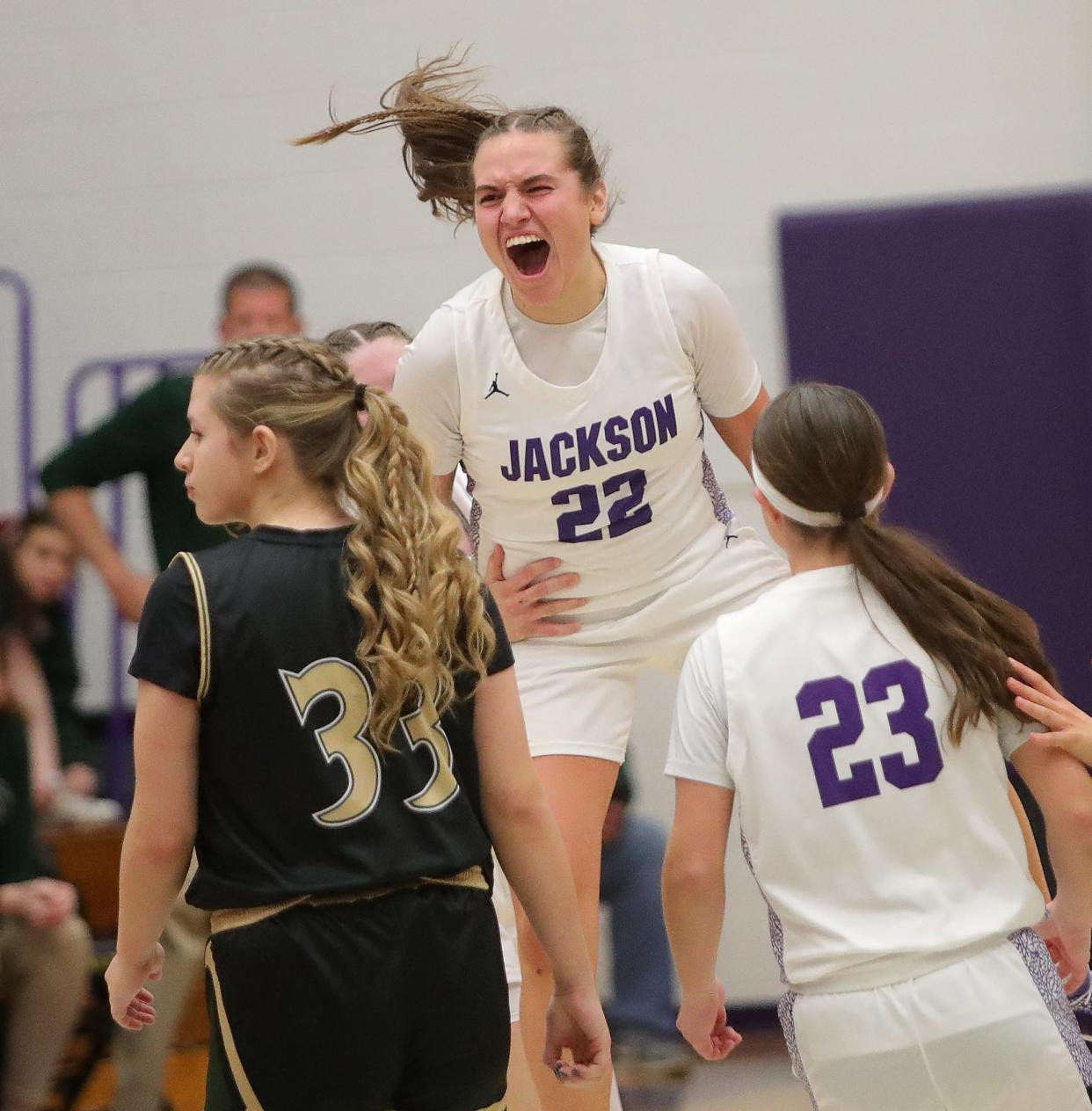 Jackson's Megan Campbell leaps into the air after making a 3-point shot as the clock expired to beat GlenOak, Friday, Dec. 22, 2023.