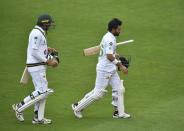 Pakistan's Mohammad Rizwan, right, and Mohammad Abbas walk off for tea during the second day of the second cricket Test match between England and Pakistan, at the Ageas Bowl in Southampton, England, Friday, Aug. 14, 2020. (Glyn Kirk/Pool via AP)