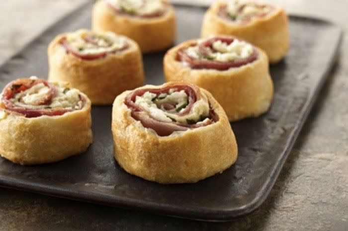 <p>The most difficult part of any party menu to plan is the appetizer. You don’t want to serve the same old boring food everyone makes, but you can’t spend too much effort on this course and neglect other dishes. The people at Pillsbury came up with this perfect solution: crescent rolls filled with prosciutto, feta cheese, and basil. Salty, warm, and easy to grab, this app will totally get your party rolling.<br><br><a href="http://www.thedailymeal.com/mediterranean-crescent-pinwheels-recipe" rel="nofollow noopener" target="_blank" data-ylk="slk:For the Mediterranean Crescent Pinwheels recipe, click here.;elm:context_link;itc:0;sec:content-canvas" class="link "><b>For the Mediterranean Crescent Pinwheels recipe, click here.</b></a></p>