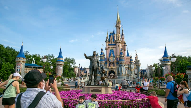 People visit the Magic Kingdom Park at Walt Disney World Resort in Lake Buena Vista, Fla., April 18, 2022. The company recently updated its Disability Access System, or DAS, for both parks.