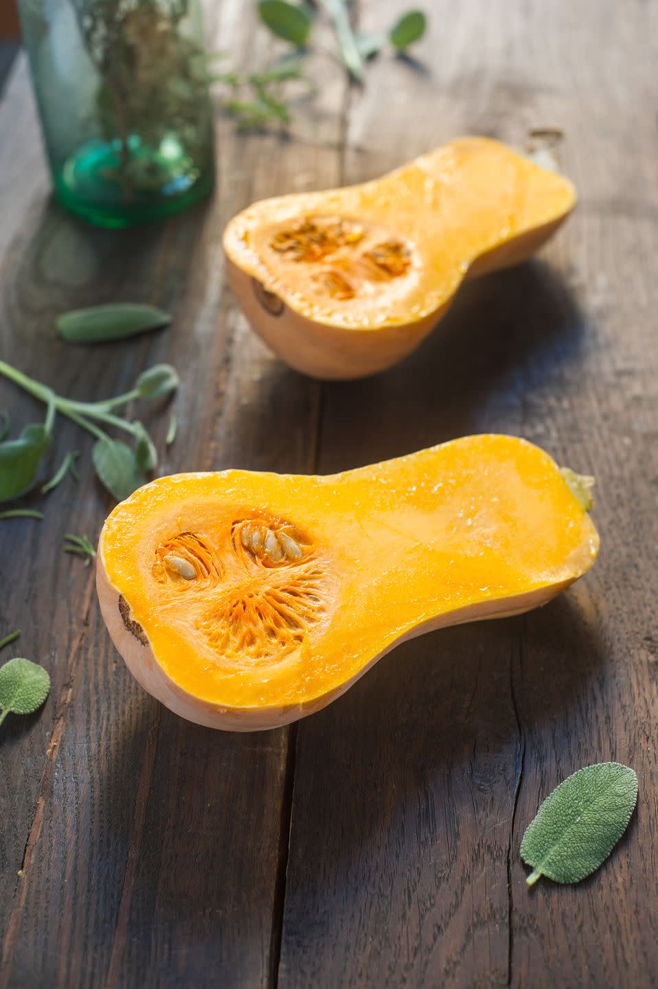 raw butternut squash on wooden table