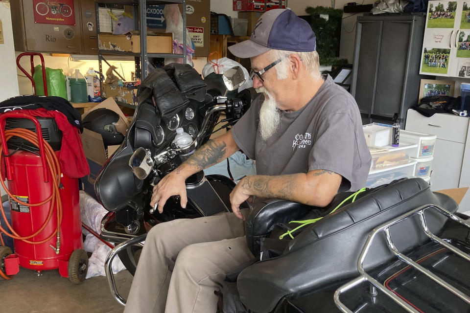 Steve Gray, a 61-year-old moderate Republican "though never a Trump fan," sits on one of his Harley Davidson motorcycles inside his garage in Rio, Wis., on Sept. 12, 2022. Gray, a school maintenance manager, said he is frustrated with the June U.S. Supreme Court decision overturning Roe v. Wade because it gave Trump a policy win despite being out of office. Gray is among voters nationally who have drifted toward supporting Democrats in November. (AP Photo/Thomas Beaumont)