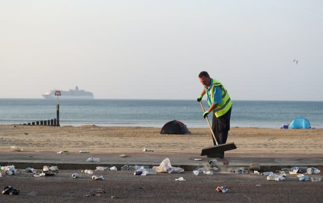 The clean-up gets under way after a busy Saturday on the beach