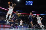 Stanford's Haley Jones shoots past UConn's Aaliyah Edwards during the second half of a college basketball game in the semifinal round of the Women's Final Four NCAA tournament Friday, April 1, 2022, in Minneapolis. UConn won 63-58 to advance to the finals. (AP Photo/Charlie Neibergall)