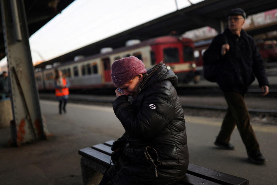 A Ukrainian refugee cries after saying goodbye to a family member at a train station.