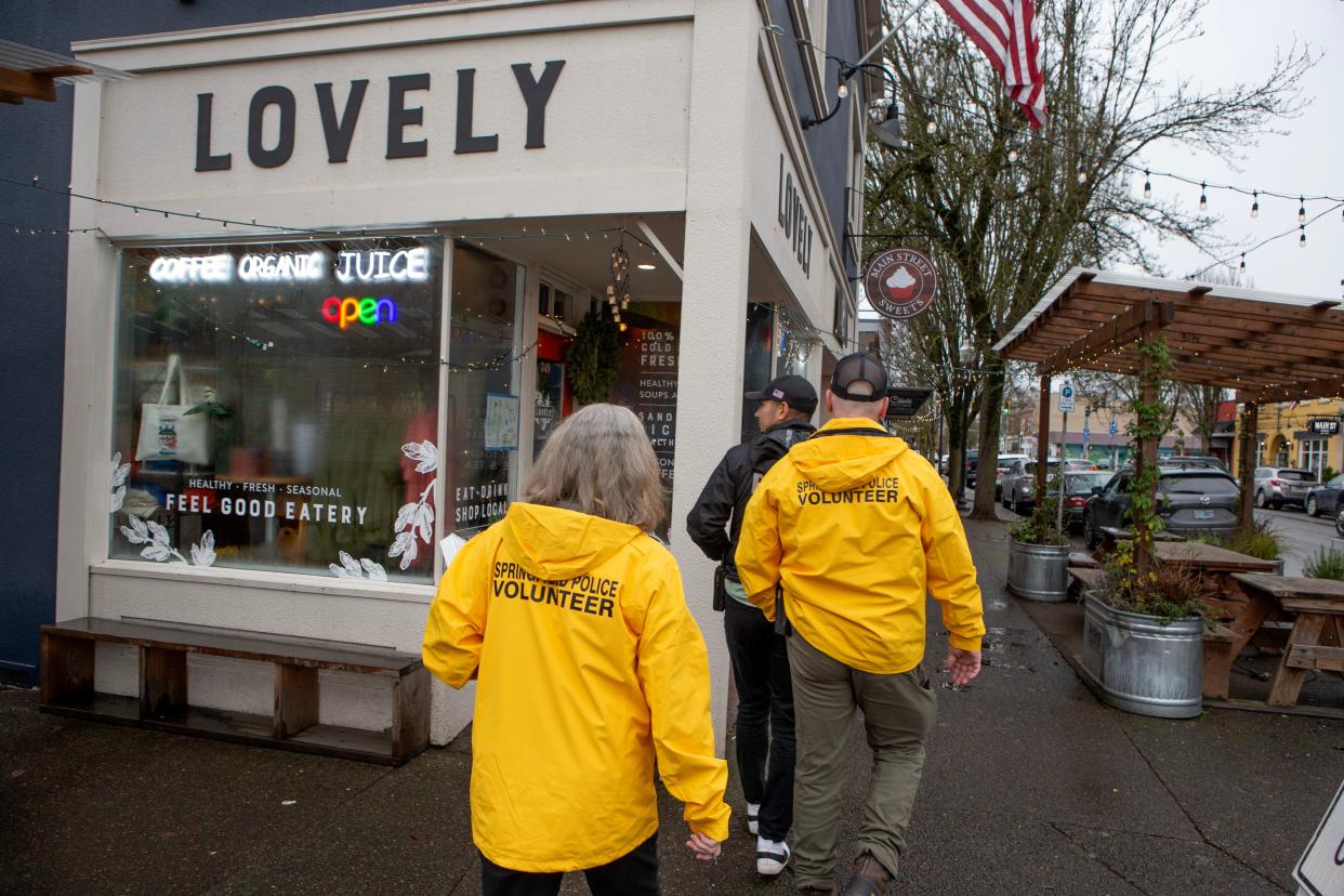 Springfield volunteers Barbara S, left, and Steve M, right, join Springfield Police Officer Chris Solares on a tour of downtown Main Street in Springfield Friday, Jan. 12, 2024.