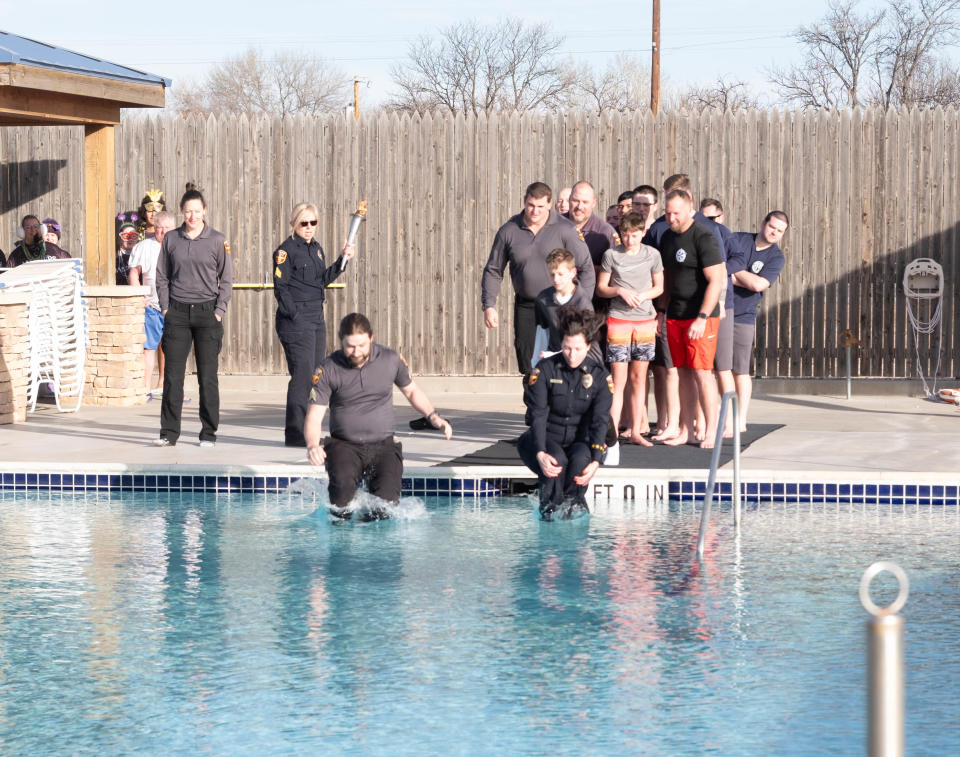 First members of the Amarillo Police Department hit the freezing water at the Polar Plunge Saturday morning at the Amarillo Town Club.