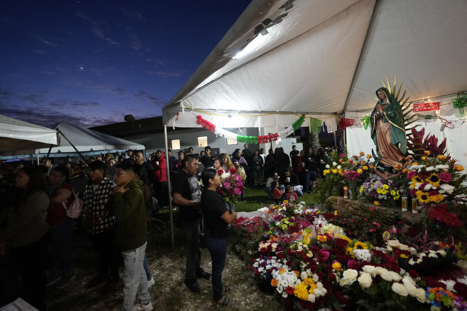 Devotees pray in front of a figure of the Virgin of Guadalupe during a festival celebrating one of several apparitions of the Virgin Mary witnessed by an indigenous Mexican man named Juan Diego in 1531, at St. Ann Mission in Naranja, Fla., Sunday, Dec. 10, 2023. For this mission church where Miami's urban sprawl fades into farmland and the Everglades swampy wilderness, it's the most important event of the year, both culturally and to fundraise to continue to minister to the migrant farmworkers it was founded to serve in 1961. (AP Photo/Rebecca Blackwell)