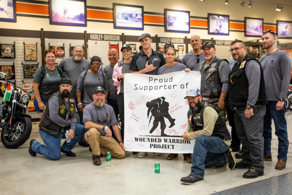 Veterans take a group photo after they rode their motorcycles from Marathon to Peterson’s Harley-Davidson South as part of a Wounded Warrior Project mental health program, “Rolling Project Odysseyâ€, in Cutler Bay, Florida, on Tuesday, October 12, 2021. The group stopped at the Harley-Davidson dealer to get a tour of the facilities.