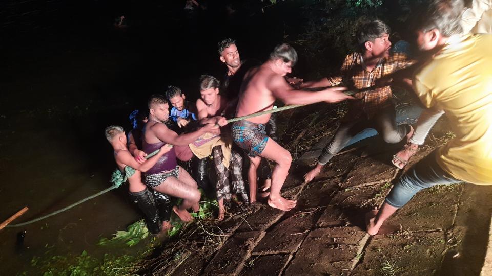 People engage in rescue work after a passenger boat carrying more than 100 people sank after a collision in a large pond in Brahmanbaria district, Bangladesh, Friday, Aug. 27, 2021. The sinking occurred in the Bijoynagar area in Brahmanbaria district in the evening, local police official Imranul Islam said by phone. Rescuers recovered at least 21 bodies by late Friday. (AP Photo)