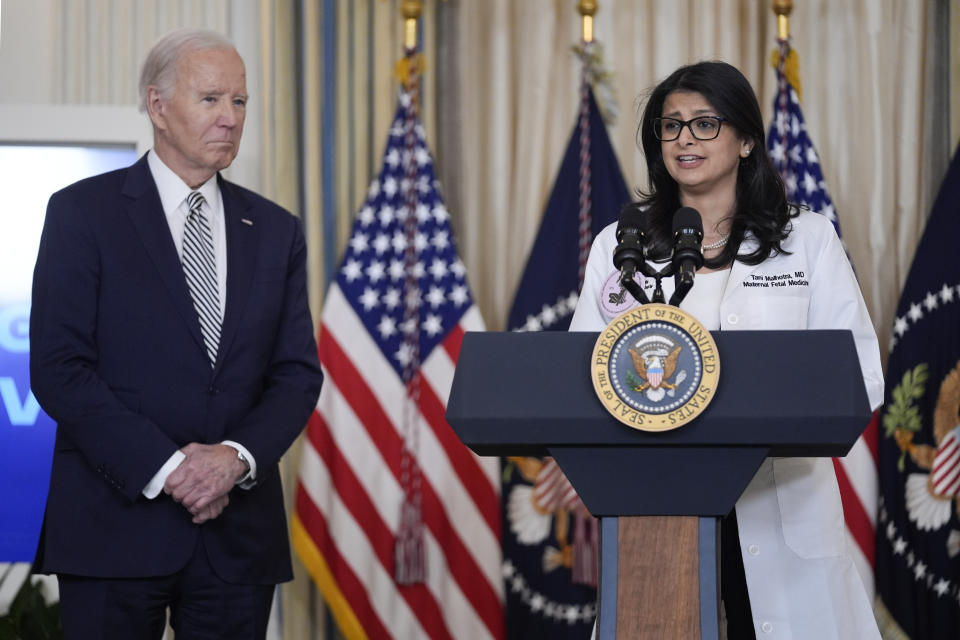 President Joe Biden looks on as Dr. Tani Malhotra, M.D., Maternal-Fetal Medicine physician and Assistant Professor of Reproductive Biology, speaks during a meeting with his reproductive rights task force to mark the 51st anniversary of the Roe v. Wade decision, in the State Dining Room of the White House, Monday, Jan. 22, 2024, in Washington. (AP Photo/Evan Vucci)