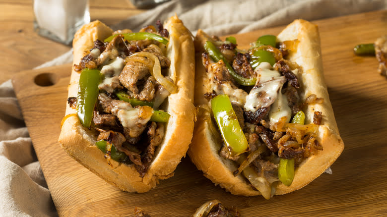 two Philly cheesesteak sandwiches