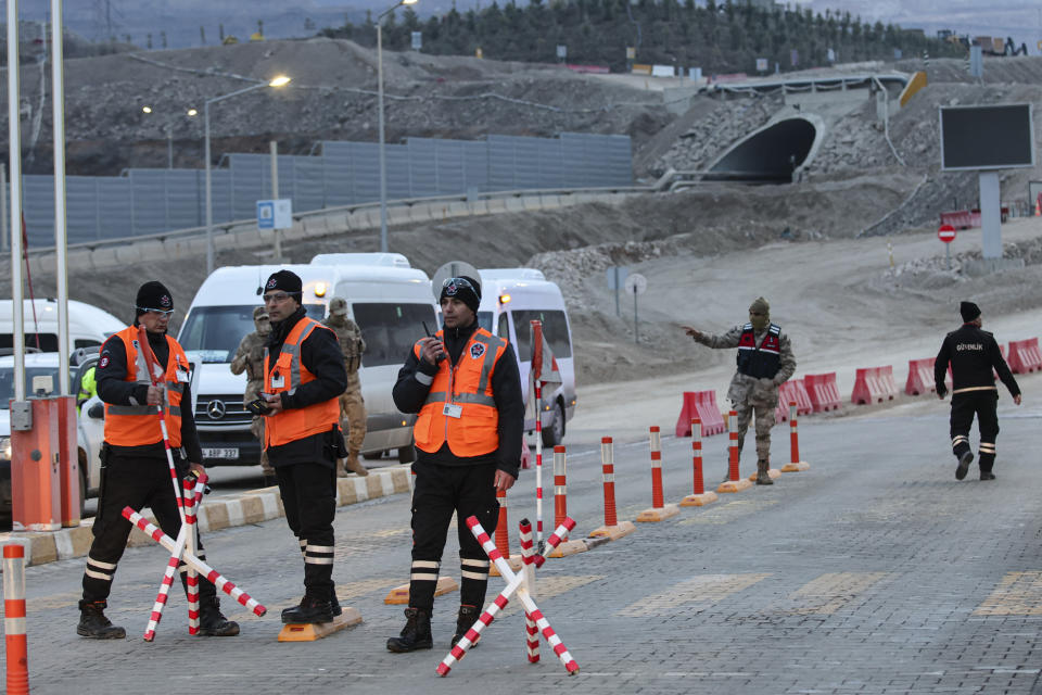 Security personnel stand at the entrance of the Copler gold mine near Ilic village, eastern Turkey, Wednesday, Feb. 14, 2024. Hundreds of rescuers on Wednesday pressed ahead with efforts to search for several workers trapped at a gold mine in eastern Turkey that was engulfed by a massive landslide.(Ugur Yildirim/Dia images via AP)