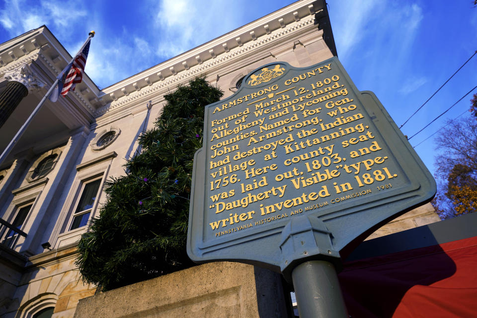 This photo from Nov. 17, 2021 shows a Pennsylvania Historical and Museum Commission plaque outside the Armstrong County Courthouse in Kittanning, Pa. A recent review of all 2,500 markers the Pennsylvania Historical and Museum Commission had been installing for more than a century, faced a fresh round of questions about just whose stories were being told on the state's roadsides, and the language used to tell them. The increased scrutiny that has focused on factual errors, inadequate historical context and racist or otherwise inappropriate references, prompting the state to remove two markers, revise two and order new text for two others so far. The changes have become grist for the political mill. (AP Photo/Gene J. Puskar)