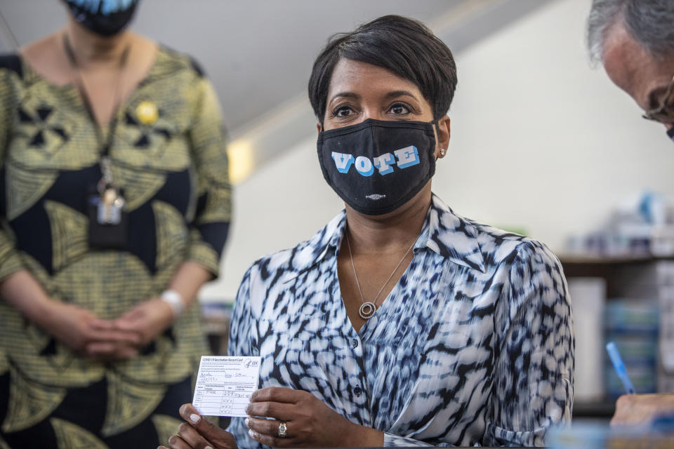 Atlanta Mayor Keisha Lance Bottoms shows off her vaccination card after receiving a Pfizer BioNTech shot by Dr. Carlos del Rio, Emory School of Medicine & Grady Health System Dean Executive Associate Dean, at Mercedes-Benz Stadium Community Vaccination Center in Atlanta, Tuesday, March 30, 2021. (Alyssa Pointer/Atlanta Journal-Constitution via AP)