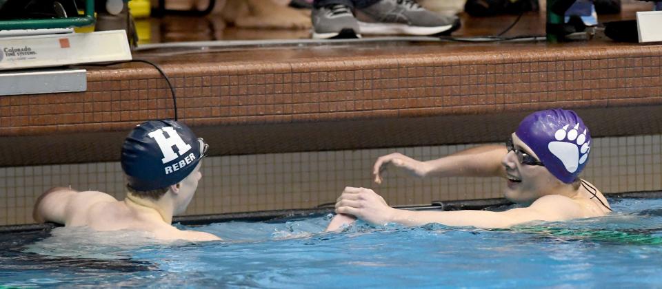 Hudson’s Ivan Reber and Jackson’s Holden Nist at the finish line of the boys 500-yard freestyle in the Division I district meet at Cleveland State, Saturday, Feb. 17, 2024.