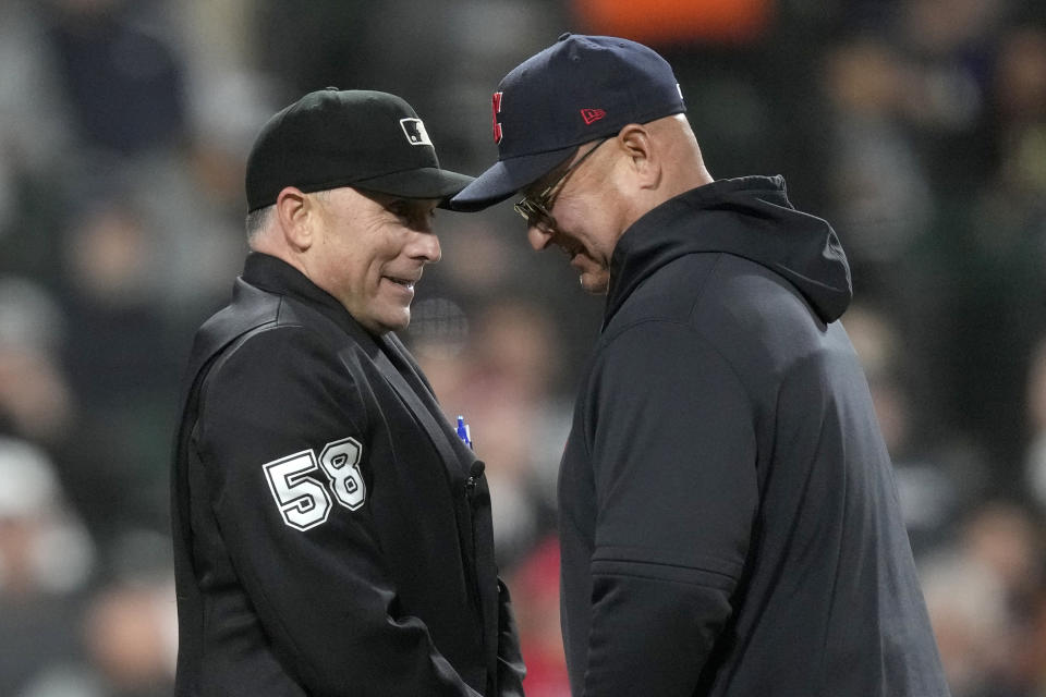 Umpire Dan Iassogna talks with Cleveland Guardians manager Terry Francona, after Francona pulled starting pitcher Peyton Battenfield during the fifth inning of the team's baseball game against the Chicago White Sox on Wednesday, May 17, 2023, in Chicago. (AP Photo/Charles Rex Arbogast)