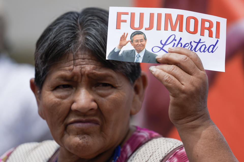 Supporters of Peru's former President Alberto Fujimori wait for his release from prison, in Callao, Peru, Wednesday, Dec. 6, 2023. The country's constitutional court ordered an immediate humanitarian release on Tuesday for the former leader who was serving a 25-year sentence for human rights abuses. (AP Photo/Martin Mejia)