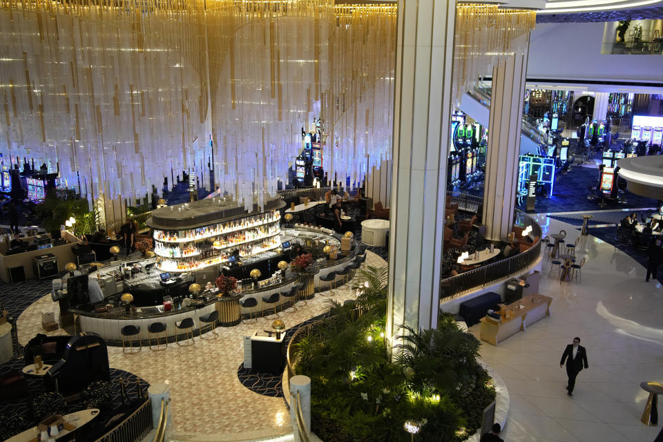 People walk by a bar in the casino at the Fontainebleau Las Vegas hotel-casino Tuesday, Dec. 12, 2023, in Las Vegas. The property is scheduled to open Wednesday. (AP Photo/John Locher)