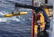 The Bluefin-21 Autonomous Underwater Vehicle is craned over the side of the Australian Defence Vessel Ocean Shield in the southern Indian Ocean during the continuing search for the missing Malaysian Airlines flight MH370 in this picture released by the Australian Defence Force April 17, 2014. REUTERS/Australian Defence Force/Handout via Reuters