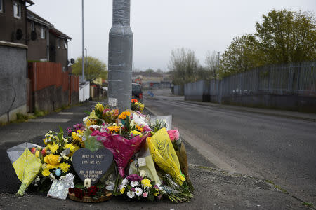 Flowers and a candle are left at the exact spot where 29-year-old journalist Lyra McKee was shot dead, in Londonderry, Northern Ireland April 20, 2019. REUTERS/Clodagh Kilcoyne