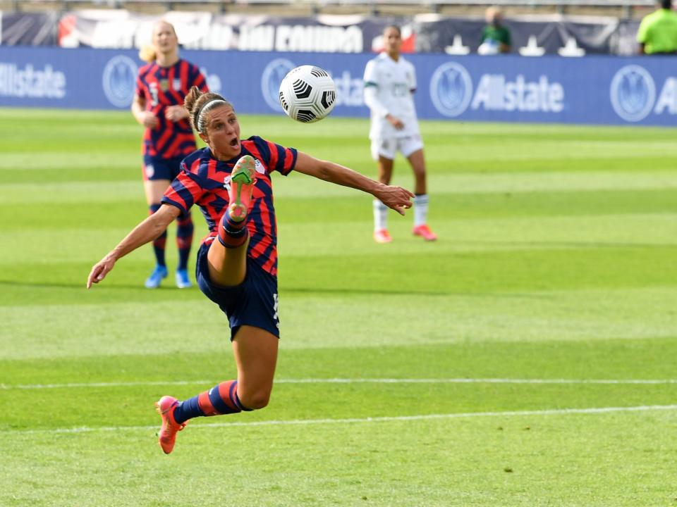 Carli Lloyd looks to settle the ball.