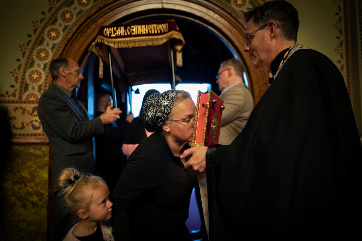 A little girl watches as her mother kisses the Gospel book as she enters St. Mary's Ukrainian Orthodox Cathedral in Allentown, Pa. 