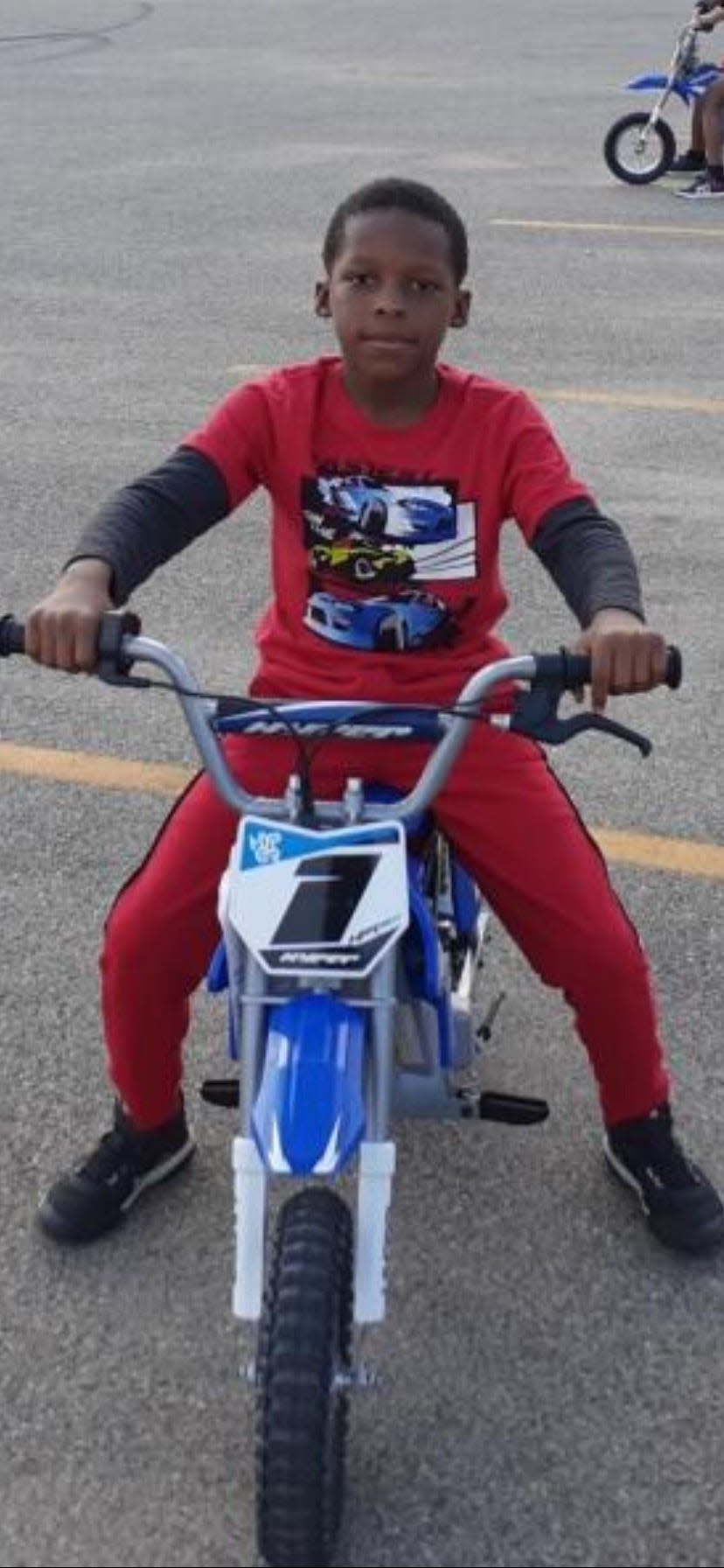 Ten-year-old Troy Erving sits on his electric-powered, dirt-bike-style bicycle in this family-supplied photo.