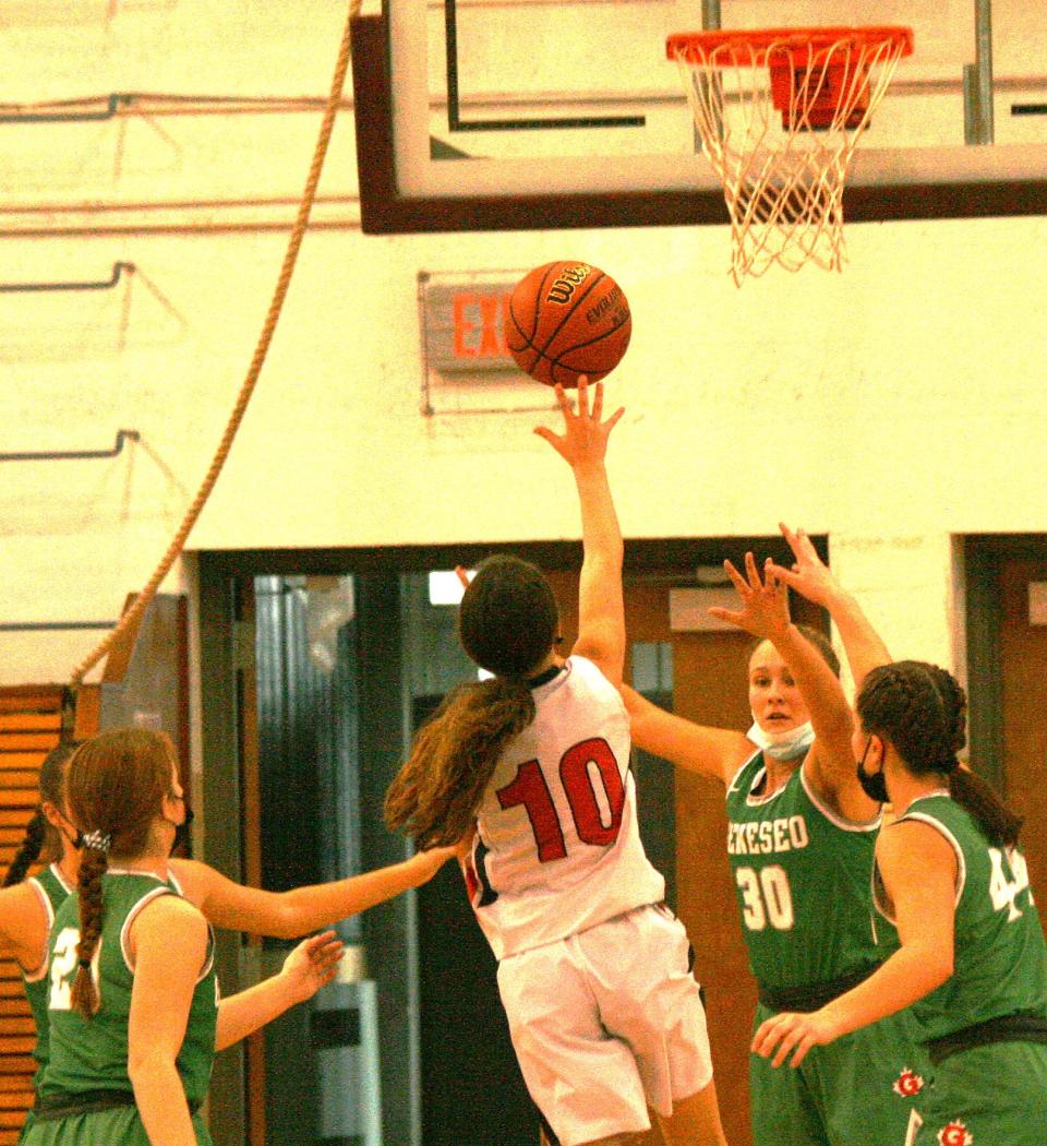 Kewanee senior guard Emily Eggimann goes up for the shot while surrounded by most of Geneseo's players.